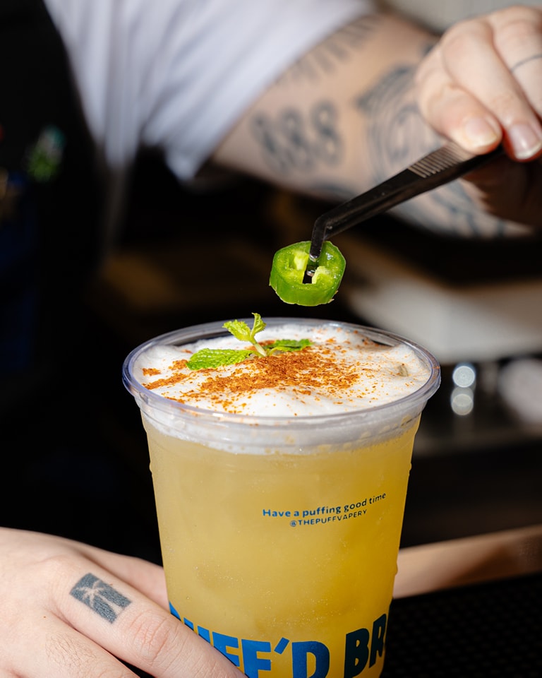 Barista shaking a signature drink