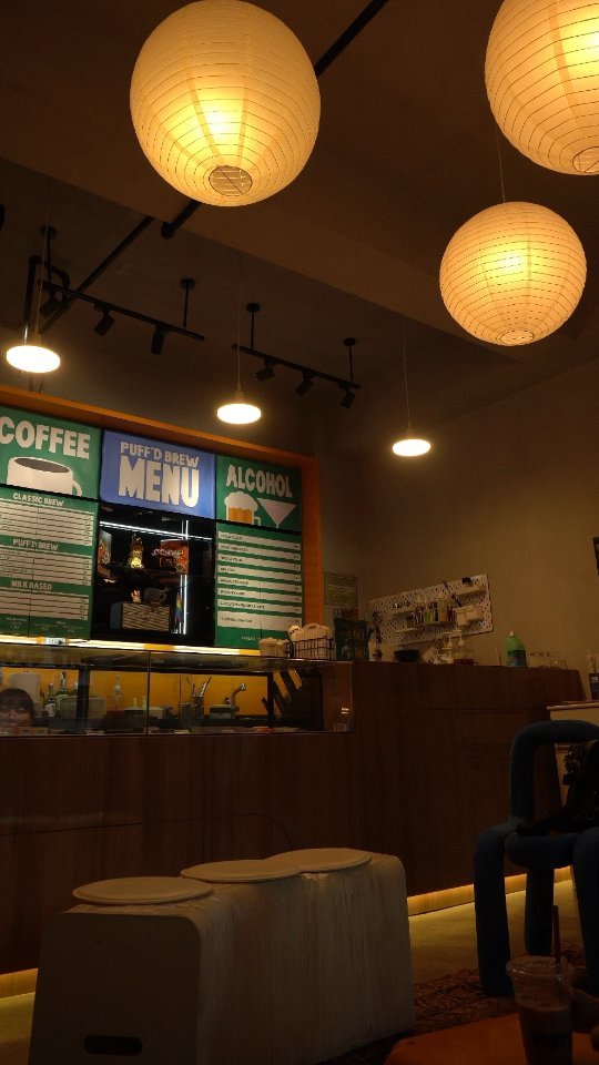 Cozy café interior with paper lanterns and menu board