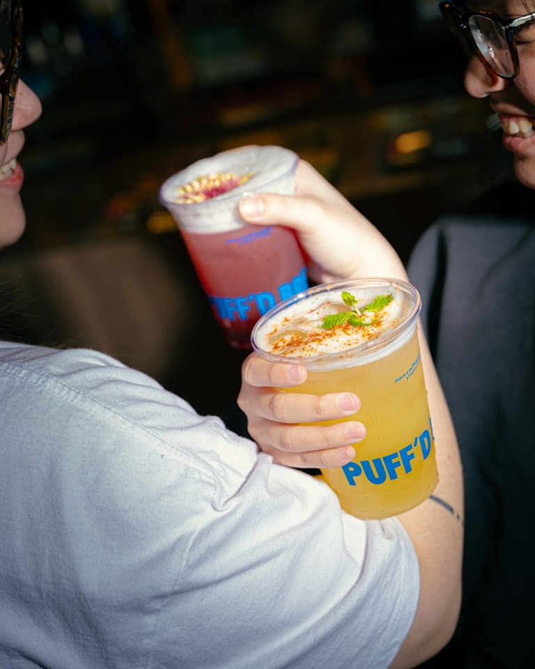Friends clinking PUFF drinks together