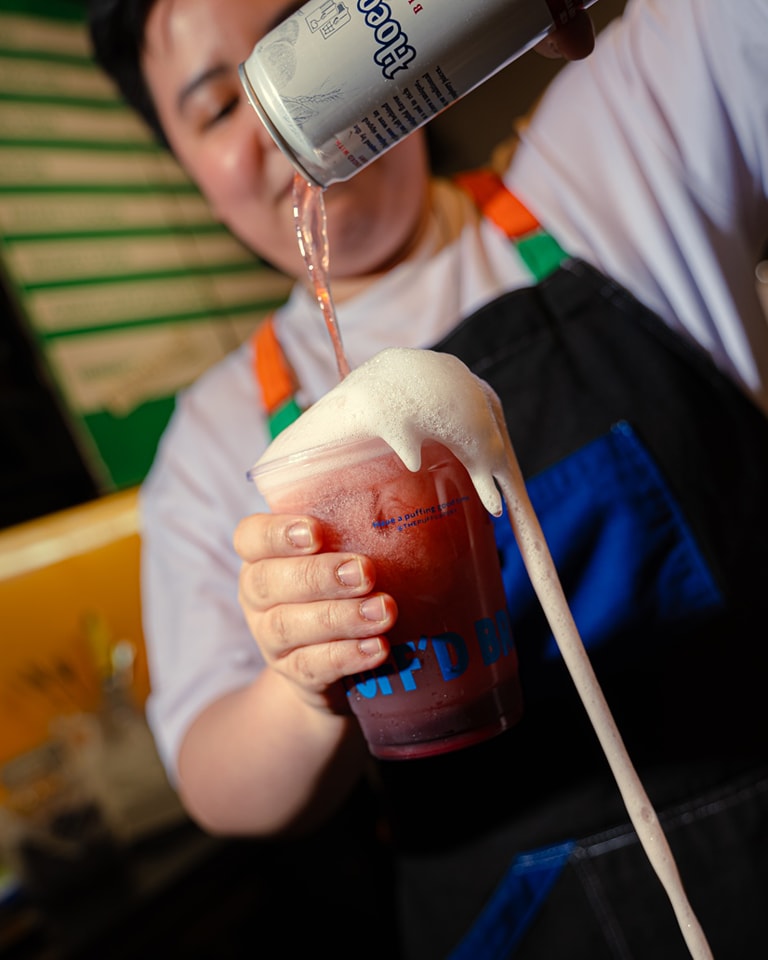 Barista pouring a foamy drink